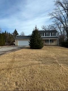 traditional home with a garage and a front yard