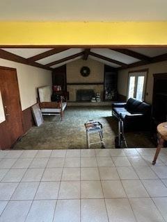 living room featuring vaulted ceiling with beams