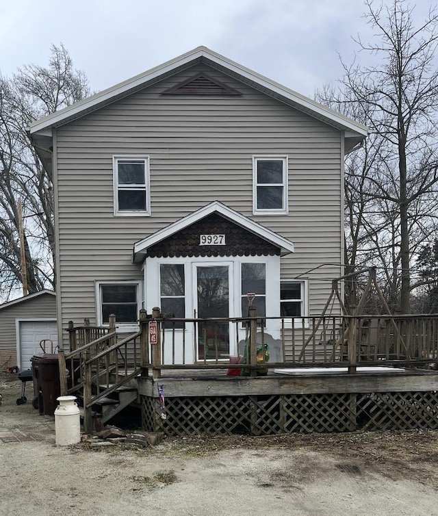 rear view of property featuring a deck