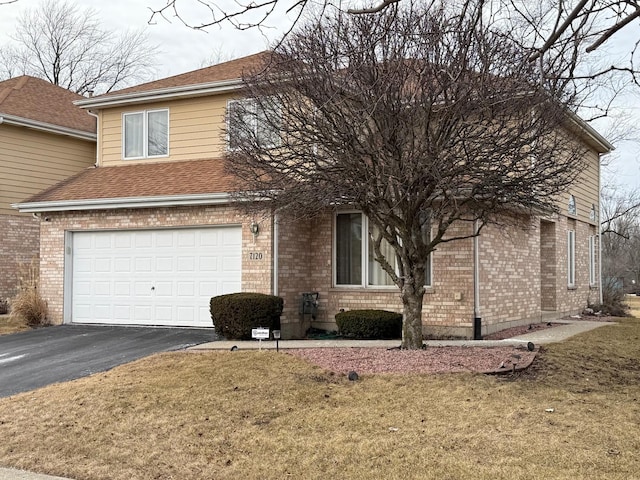 traditional home featuring a shingled roof, brick siding, driveway, and an attached garage