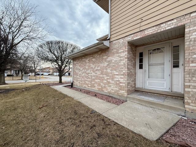 entrance to property with brick siding