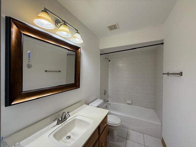 bathroom featuring visible vents, toilet, tile patterned floors, tub / shower combination, and vanity