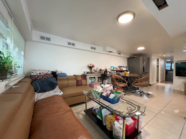 living area featuring visible vents and light tile patterned floors