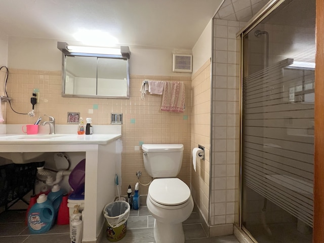 bathroom featuring a stall shower, visible vents, toilet, tile patterned flooring, and tile walls