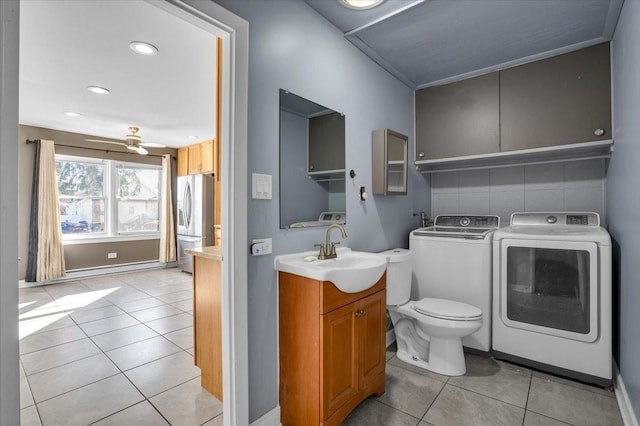 bathroom featuring toilet, ceiling fan, vanity, separate washer and dryer, and tile patterned floors