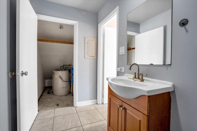 bathroom with water heater, tile patterned flooring, vanity, and baseboards