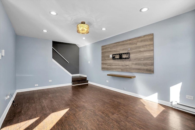 unfurnished living room with a baseboard heating unit, recessed lighting, baseboards, and wood finished floors