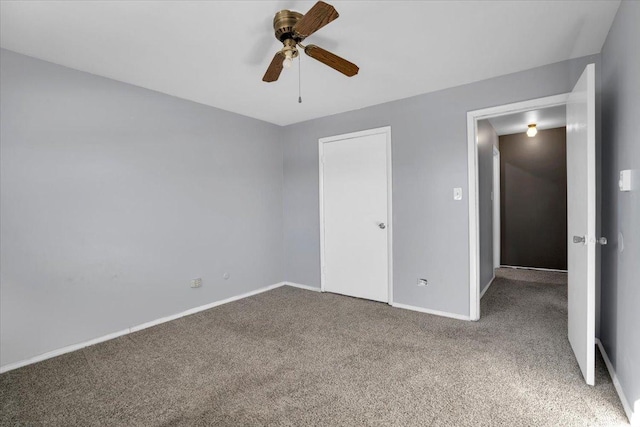 unfurnished bedroom featuring a ceiling fan, carpet, and baseboards