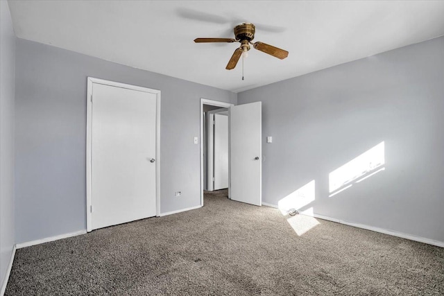 unfurnished bedroom featuring carpet, baseboards, and a ceiling fan