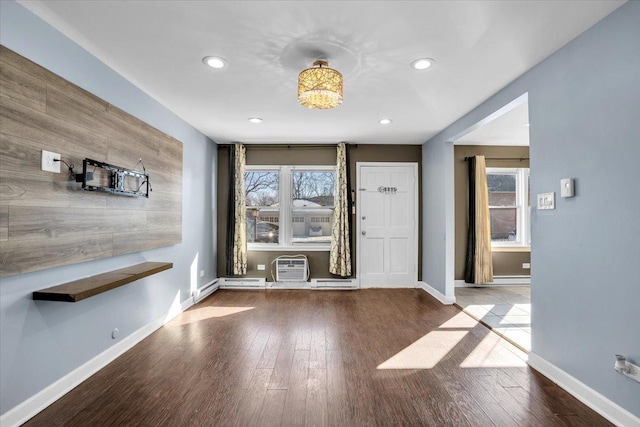 entrance foyer featuring recessed lighting, a healthy amount of sunlight, baseboards, and wood finished floors