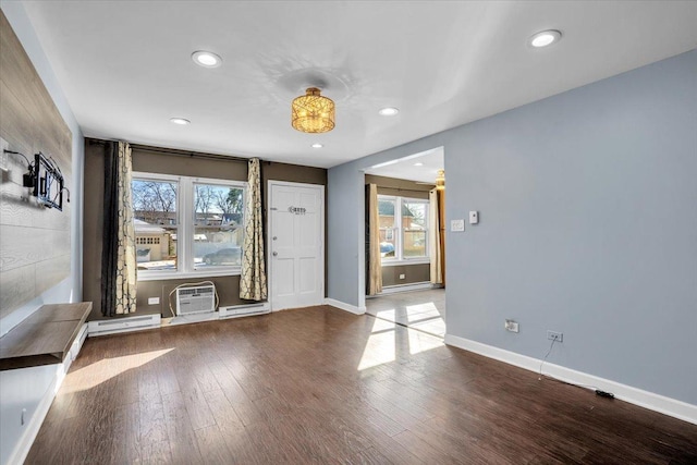 foyer with baseboards, a wall unit AC, a baseboard radiator, wood finished floors, and recessed lighting