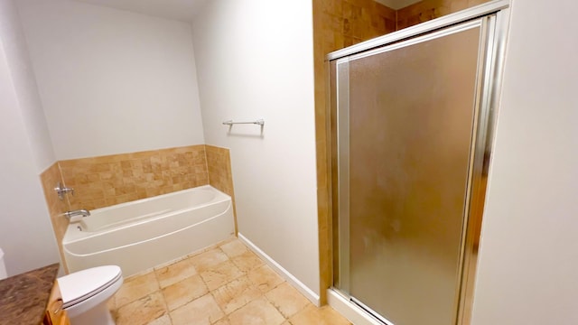 bathroom with a garden tub, toilet, baseboards, a shower stall, and stone finish flooring