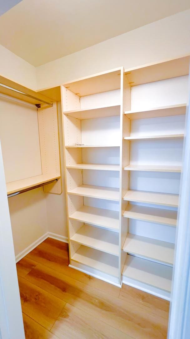 spacious closet with wood finished floors