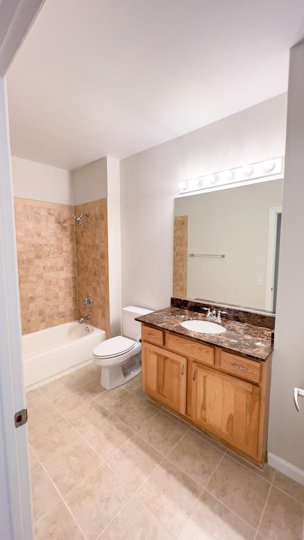 full bath featuring bathtub / shower combination, tile patterned flooring, vanity, and toilet