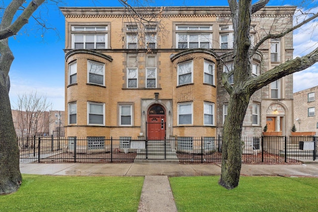 view of front of property featuring fence and brick siding