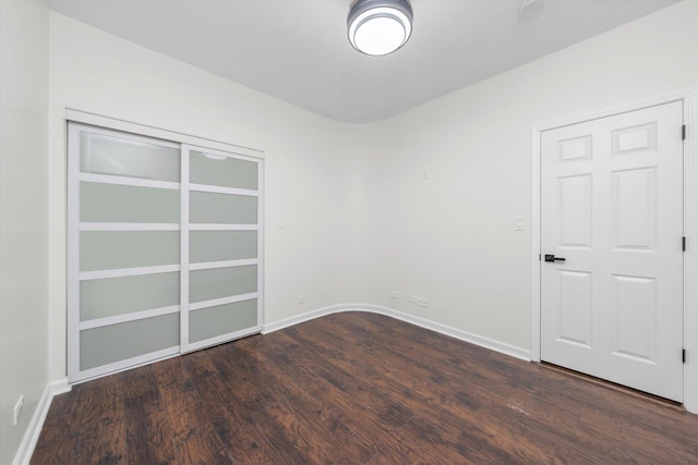 empty room featuring baseboards and wood finished floors