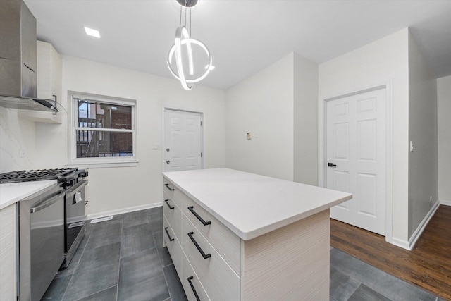 kitchen with a center island, light countertops, stove, wall chimney range hood, and modern cabinets