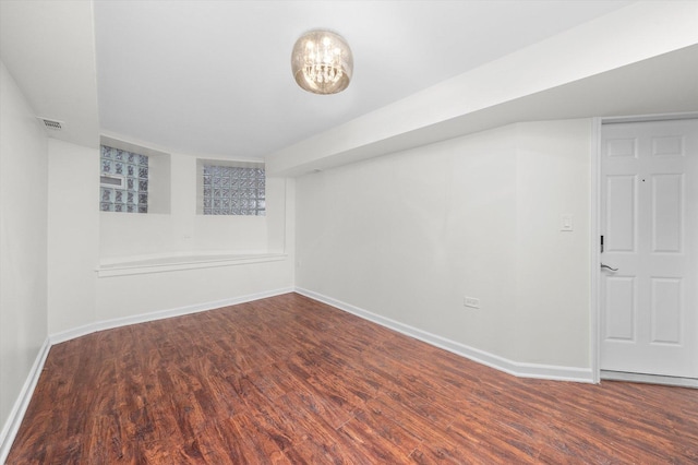 interior space with wood finished floors, visible vents, and baseboards