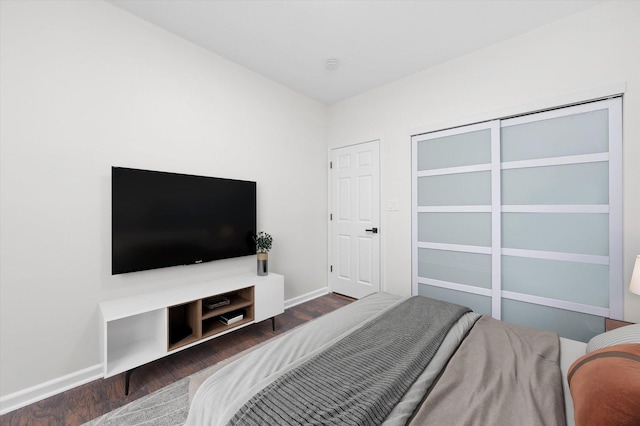 bedroom with baseboards and wood finished floors