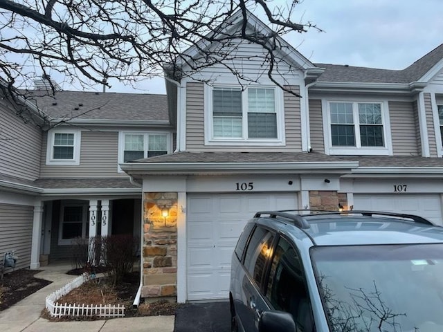 view of front of home with stone siding and an attached garage