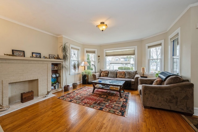 living area featuring a brick fireplace, wood finished floors, and a wealth of natural light