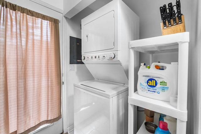 washroom with laundry area and stacked washing maching and dryer