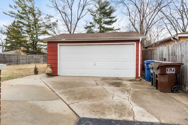 detached garage featuring fence