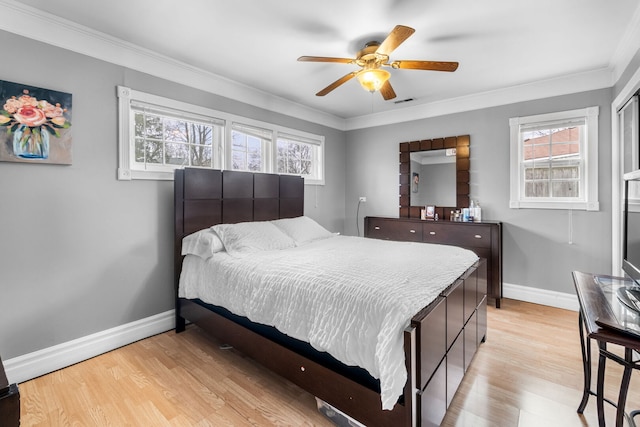 bedroom featuring multiple windows, crown molding, and light wood-style flooring