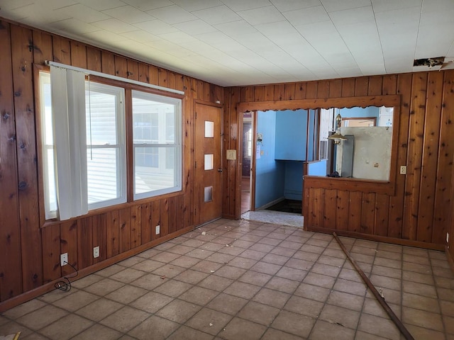 interior space featuring wooden walls and baseboards