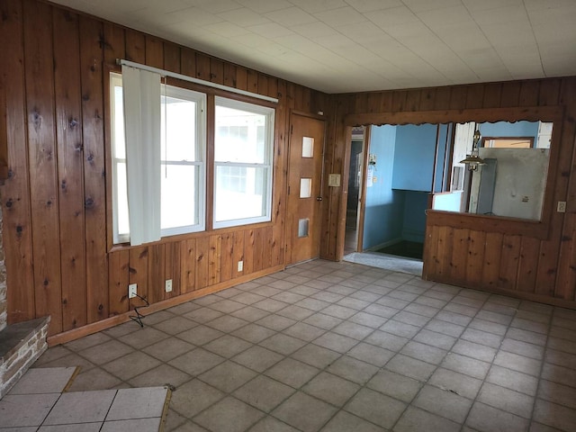 interior space featuring wood walls and baseboards