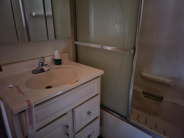 full bath featuring shower / bath combination with glass door and vanity