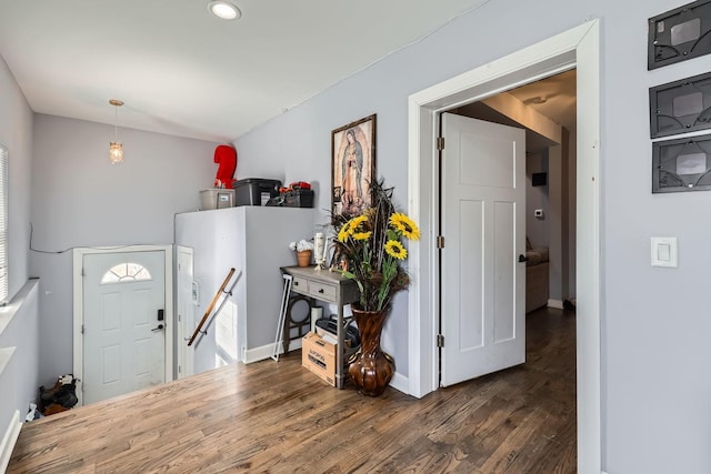 foyer with baseboards and dark wood-style flooring