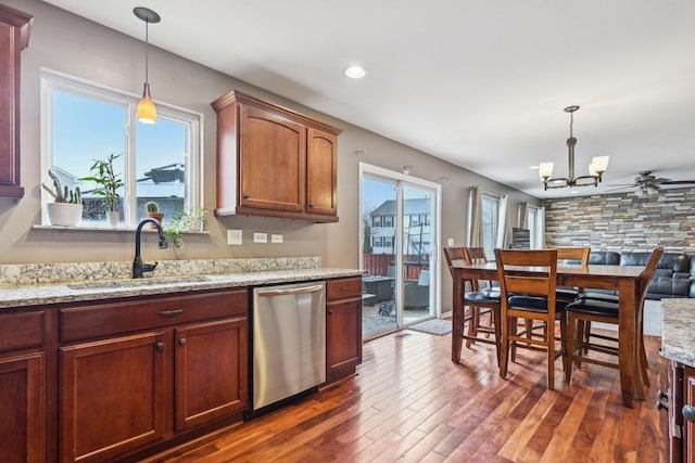 kitchen with dishwasher, plenty of natural light, a sink, and dark wood-style floors