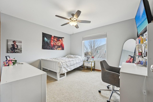 bedroom with light carpet, ceiling fan, and baseboards