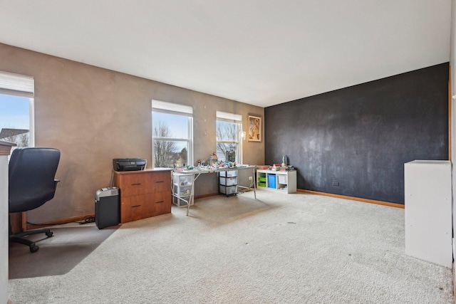 carpeted home office featuring baseboards