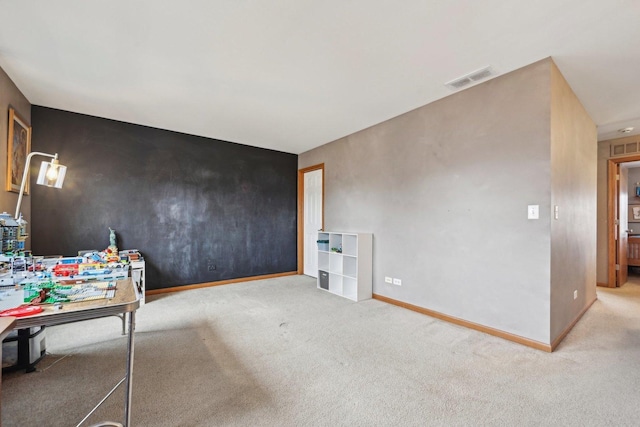 interior space with carpet floors, visible vents, and baseboards