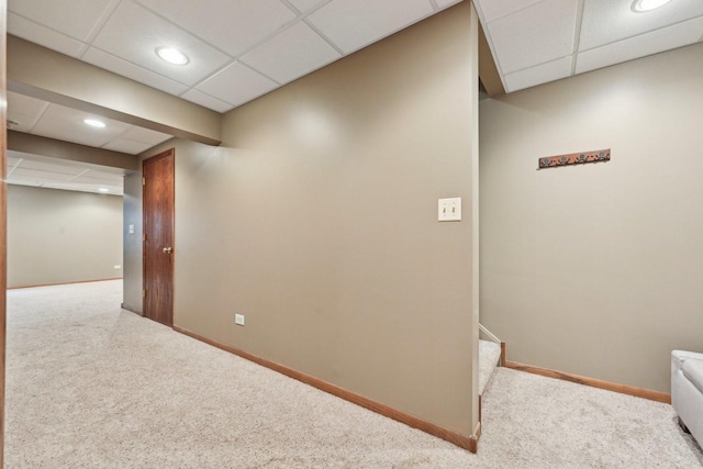 interior space featuring a paneled ceiling, carpet, baseboards, and recessed lighting