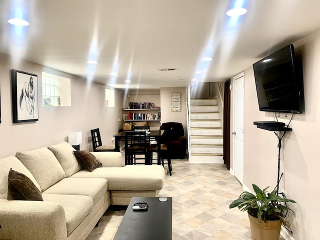 living room featuring stairway