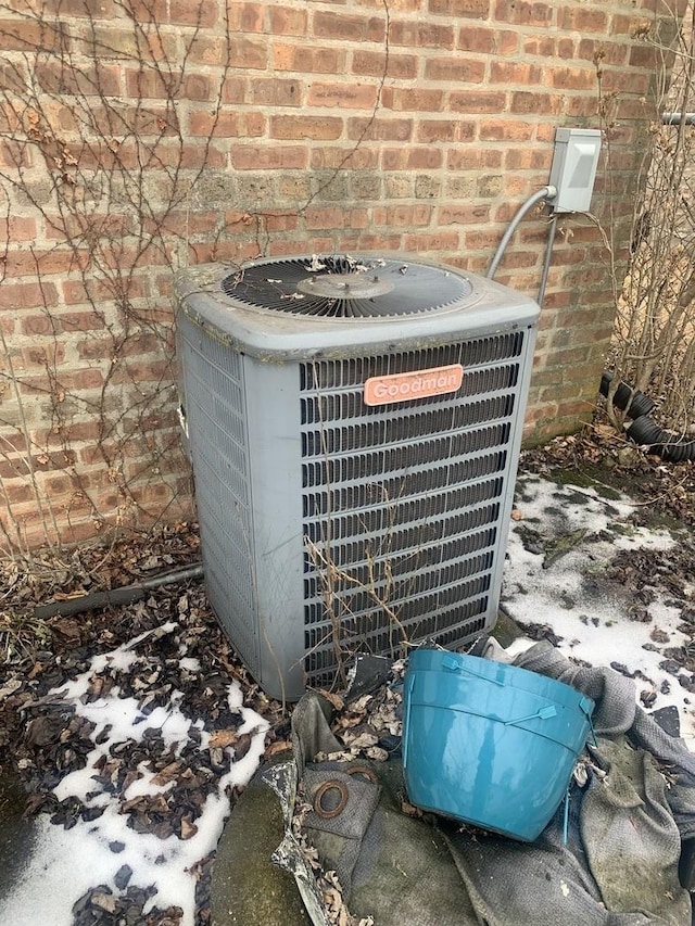 exterior details with brick siding and central air condition unit