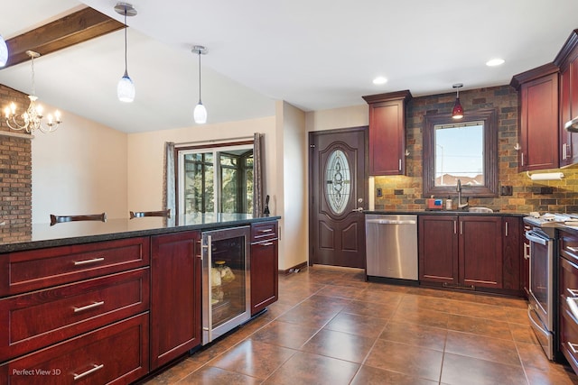 kitchen featuring beverage cooler, stainless steel appliances, a sink, reddish brown cabinets, and decorative light fixtures