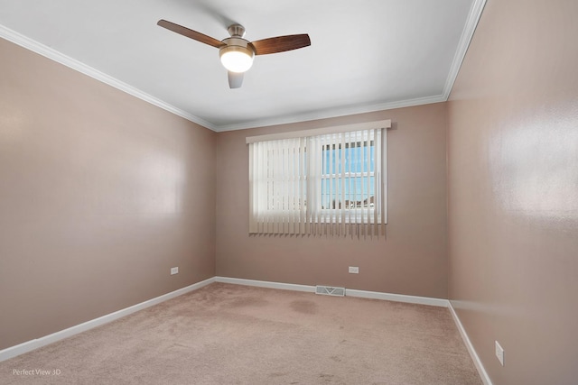 empty room with crown molding, visible vents, a ceiling fan, light carpet, and baseboards