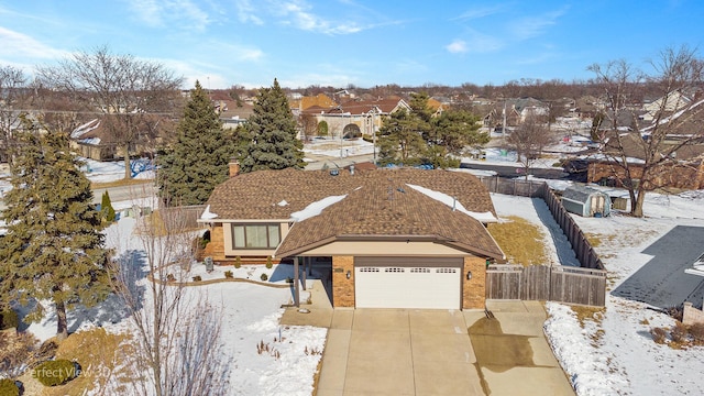 snowy aerial view with a residential view