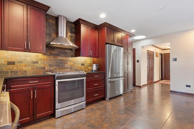 kitchen featuring stainless steel appliances, dark brown cabinets, wall chimney exhaust hood, and backsplash