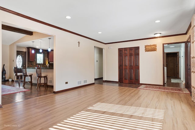 living area with ornamental molding, recessed lighting, baseboards, and wood finished floors