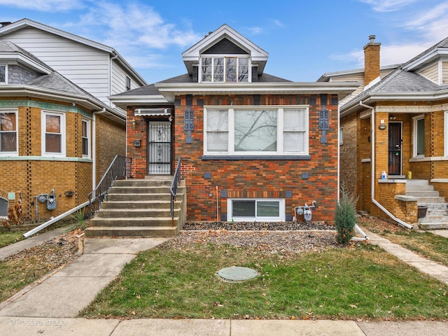 bungalow-style home featuring brick siding