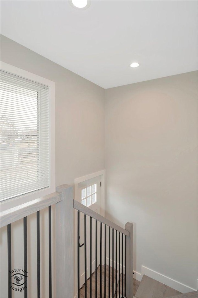 stairway with recessed lighting, baseboards, and wood finished floors