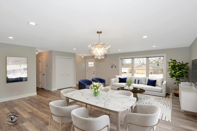 dining space with light wood-type flooring and recessed lighting