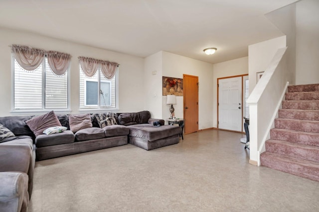 living room featuring stairway and baseboards