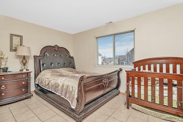 bedroom featuring light tile patterned floors and visible vents