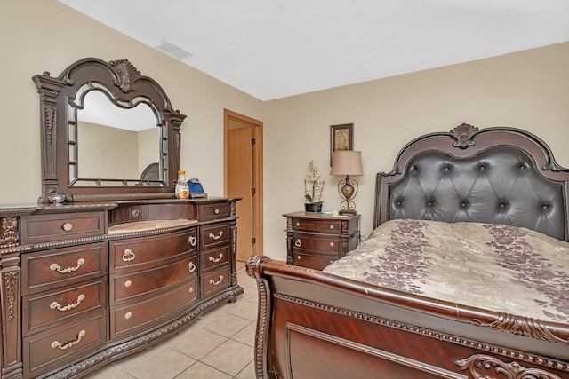 bedroom featuring light tile patterned floors and visible vents